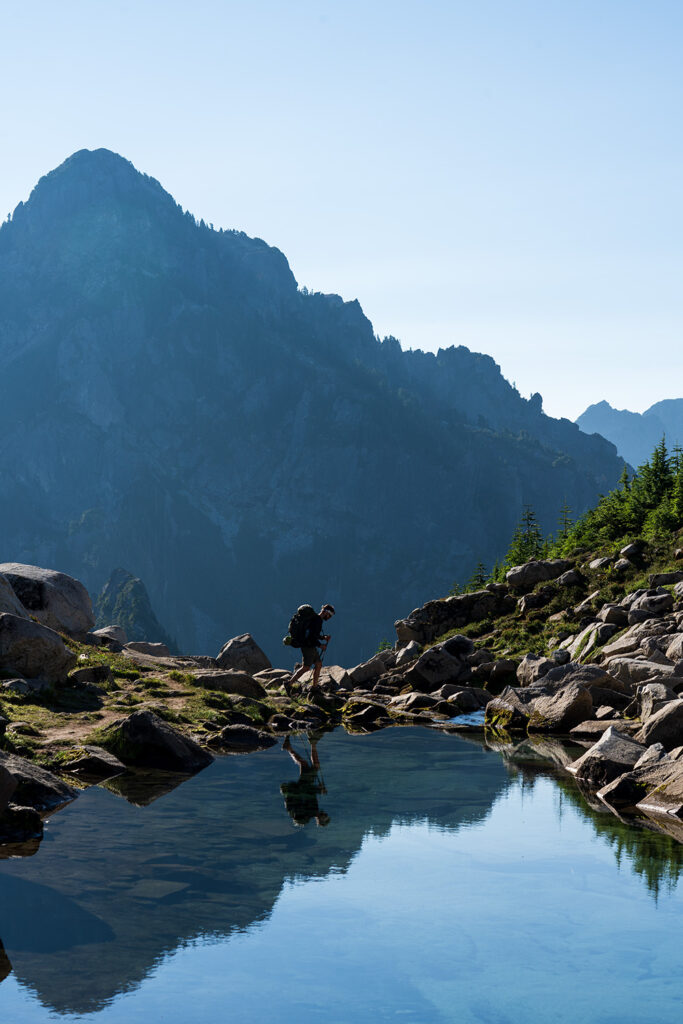 hiker crossing stream from elan lake